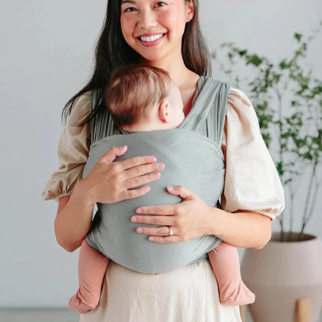 Woman wearing baby in Solly Baby Wrap - Mist