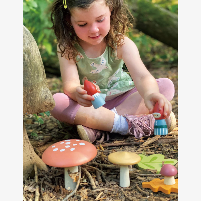 Girl plays outside with Tender Leaf Toys Woodland Gnome Family