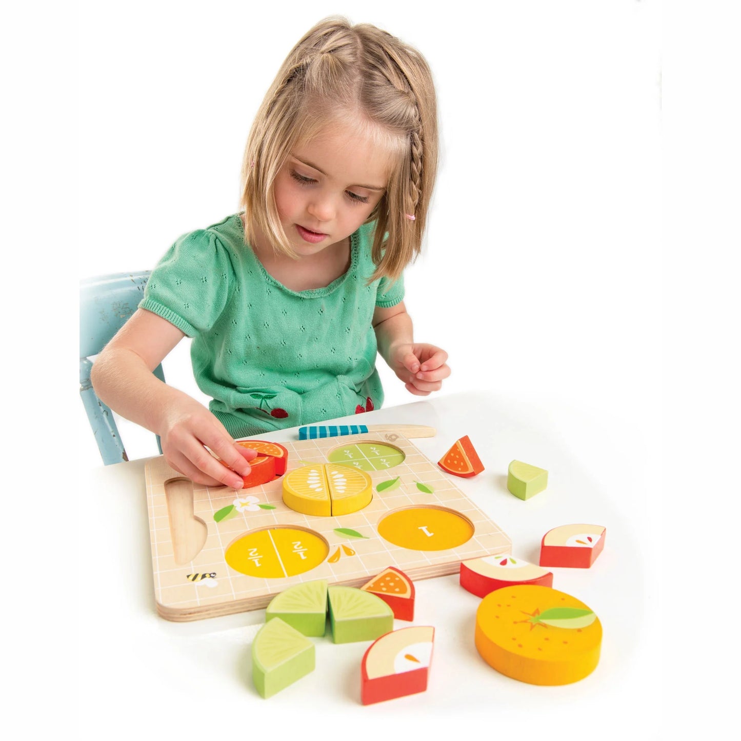 Girl plays with Tender Leaf Toys Citrus Fractions