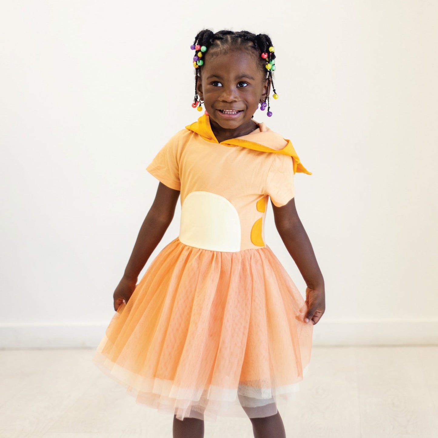 Little girl wearing Taylor Joelle Orange Doggo Dress