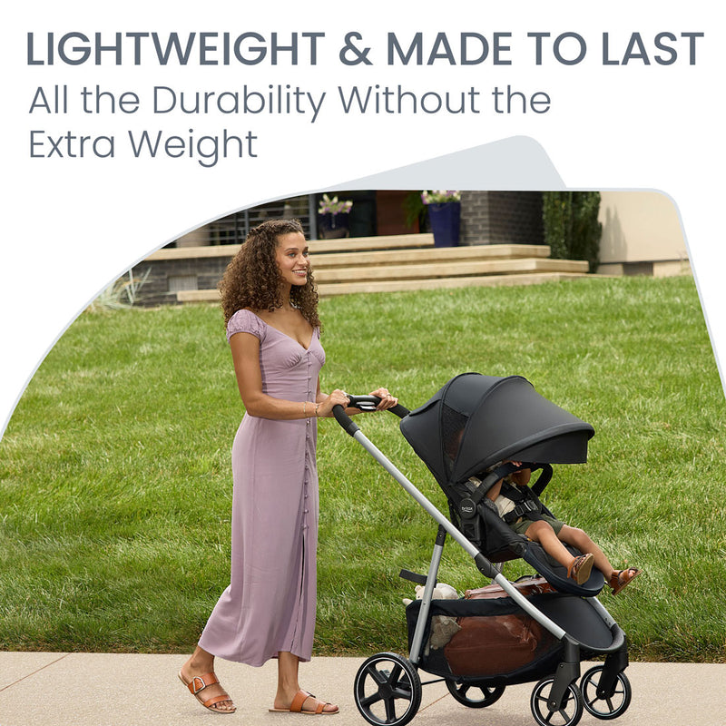 Mom pushes toddler in Britax Grove Modular Stroller - Pindot Onyx
