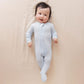Baby wearing WildBird CloudBlend™ Footed Pajamas - Dove - 3-6M