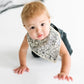 Baby wearing Copper Pearl Single Holiday Bandana Bib - patch spiderwebs