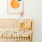 Baby in Crib with Cotton Muslin Crib Sheet - Clementine