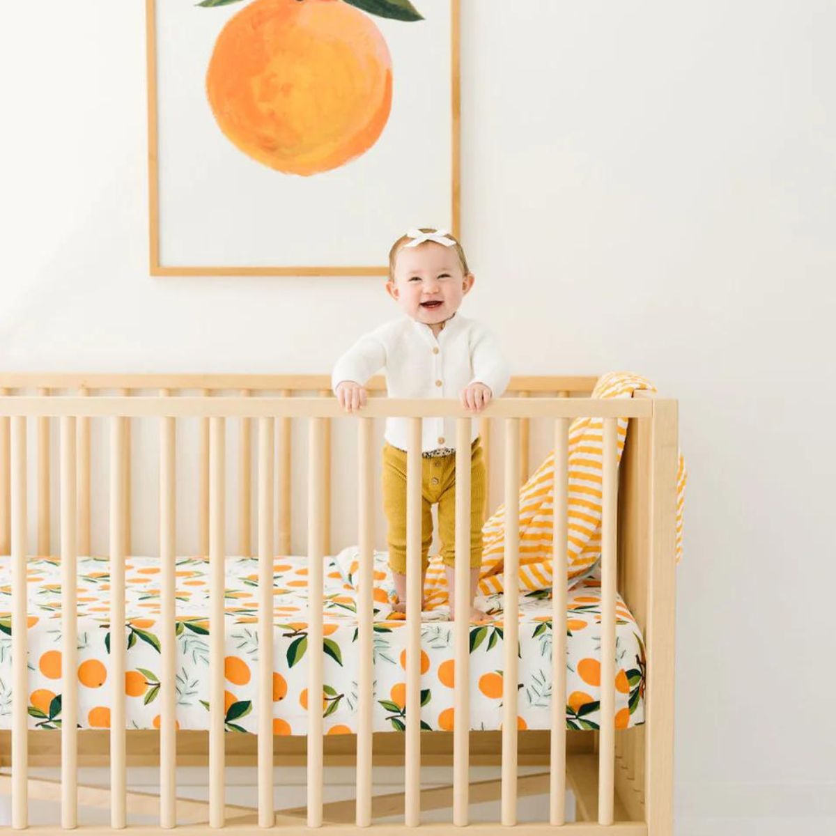 Baby in Crib with Cotton Muslin Crib Sheet - Clementine