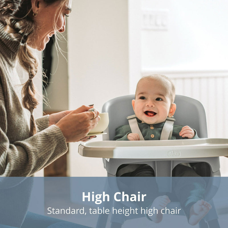 Mom feeds baby sitting in Chicco Zest 4-in-1 Folding High Chair - Seasalt