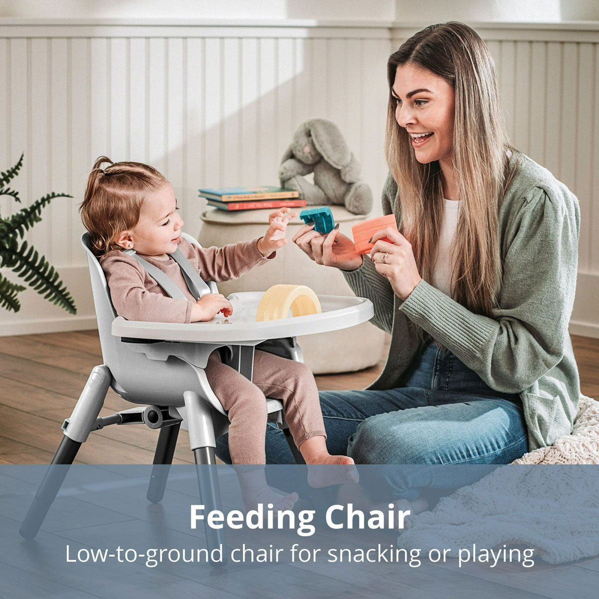 Mom shows baby toys as she sits in Chicco Zest 4-in-1 Folding High Chair - Seasalt