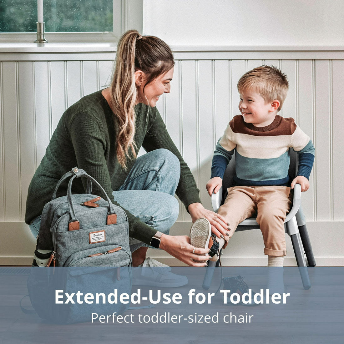 Mom puts shoes on little boy while he sits in Chicco Zest 4-in-1 Folding High Chair - Seasalt in stool mode
