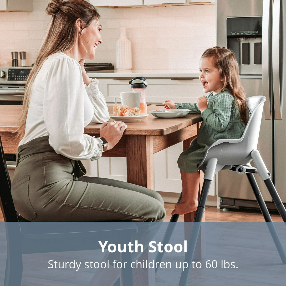 Mom eats breakfast at table with young girl sitting in Chicco Zest 4-in-1 Folding High Chair - Seasalt