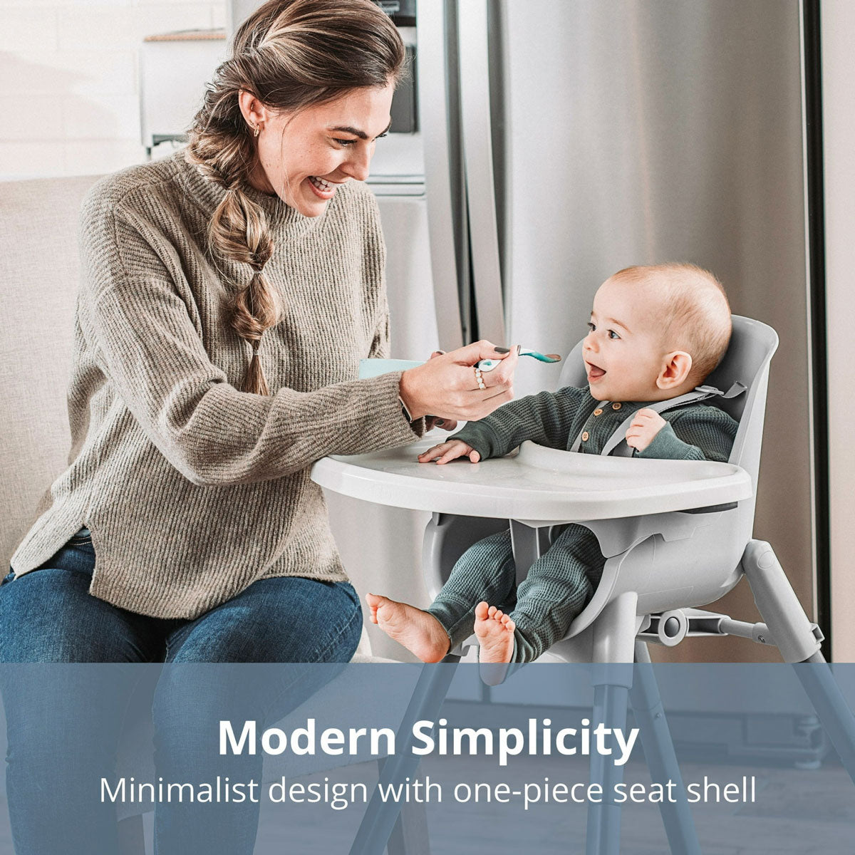 Mom feeds puree to baby sitting in Chicco Zest 4-in-1 Folding High Chair - Seasalt