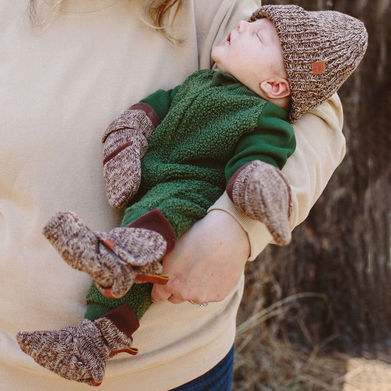 Newborn wearing goumikids Knit Mitts - Bark
