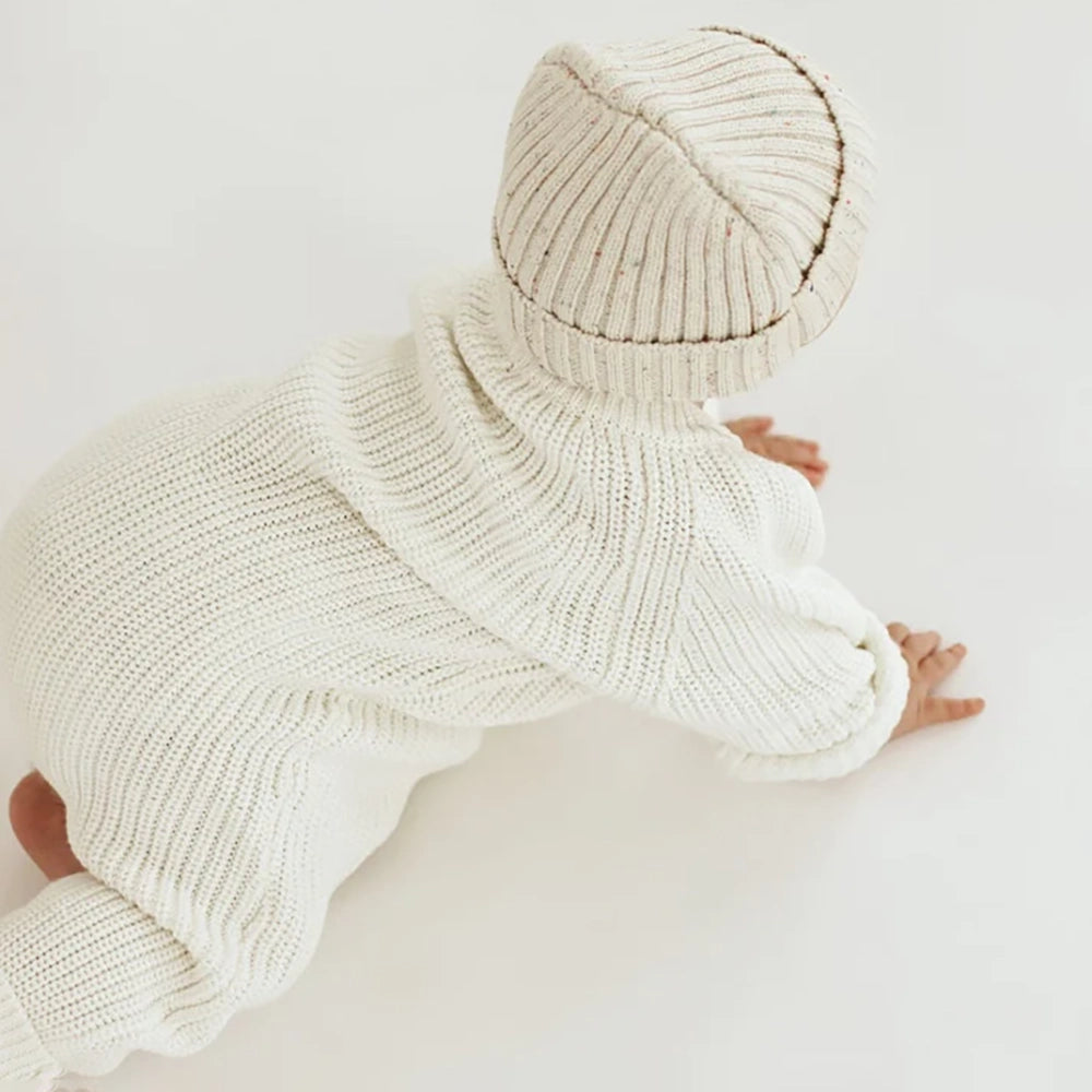 baby wearing Oat and Co Chunky Knit Playsuit - Powder