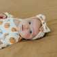Baby wearing Copper Pearl Seasonal Knit Headband Bow - Karver