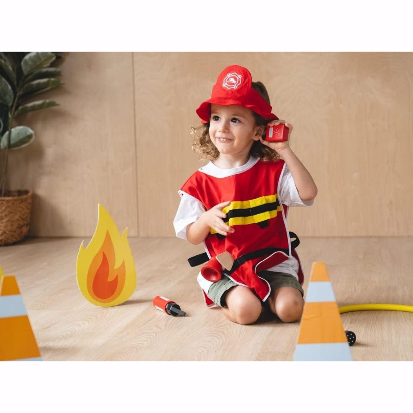 Little girl plays with PlanToys Fire Fighter Play Set