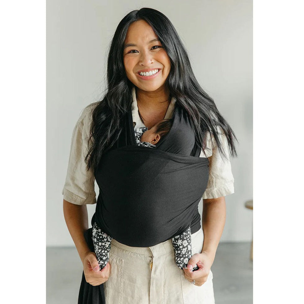 Mom carrying baby in Solly Baby Wrap - Black
