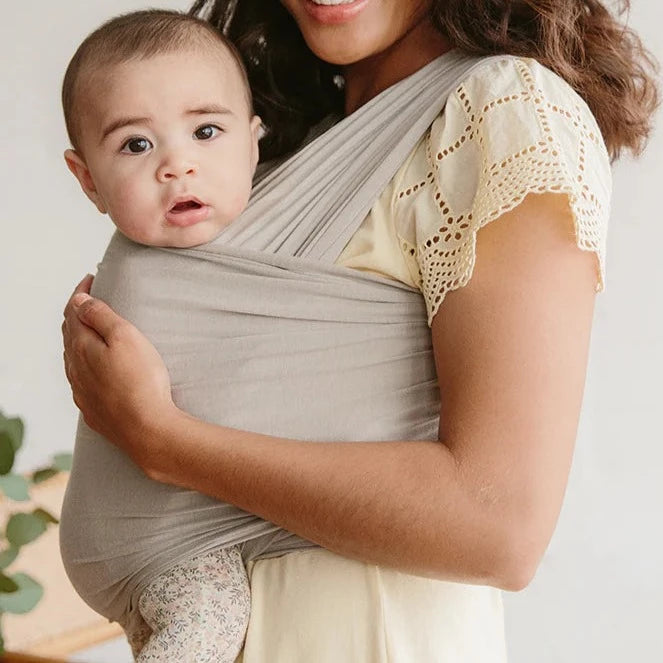 Woman wearing baby in Solly Baby Wrap - Spelt
