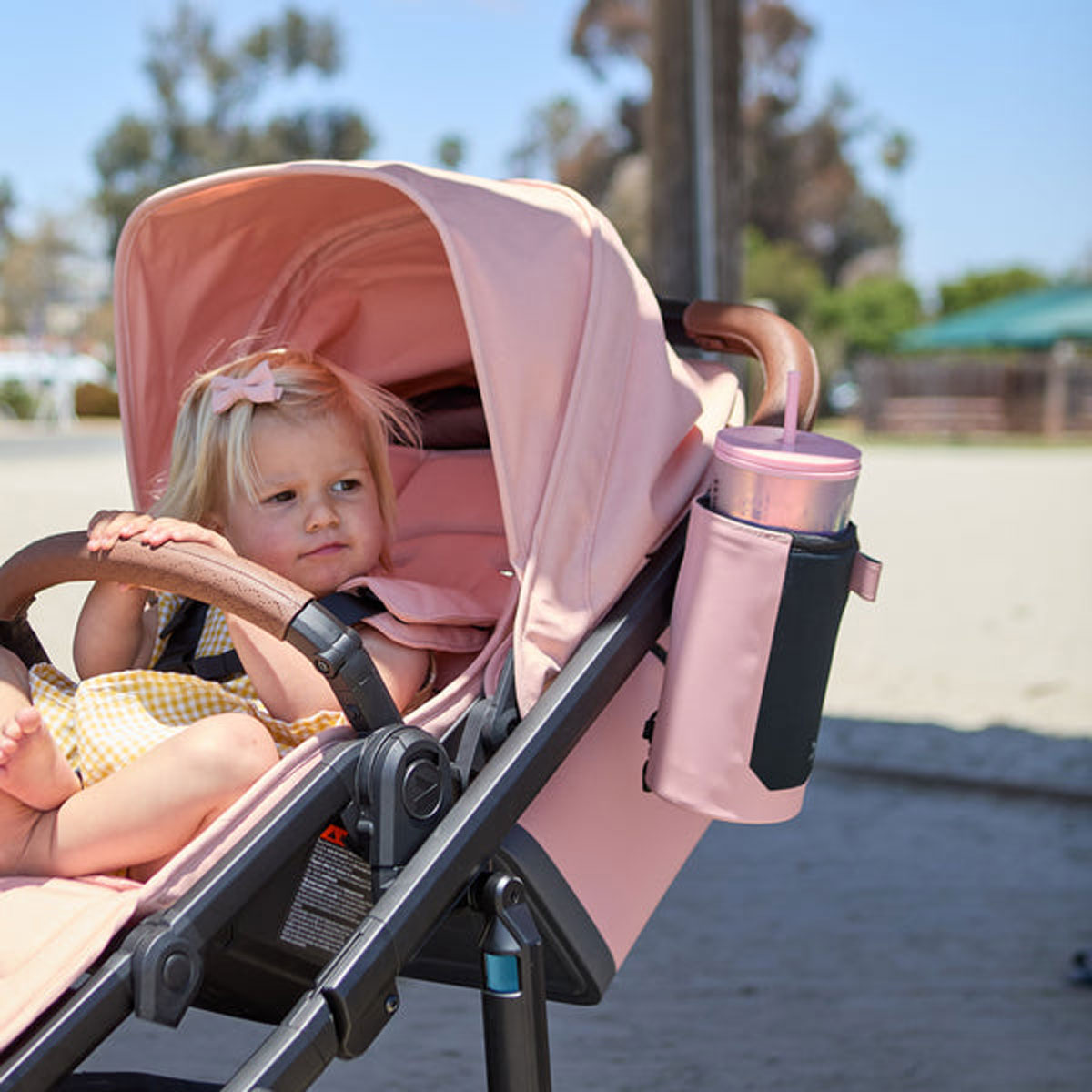 Baby sitting in stroller with Veer Catch All XL - Rose Quartz attached