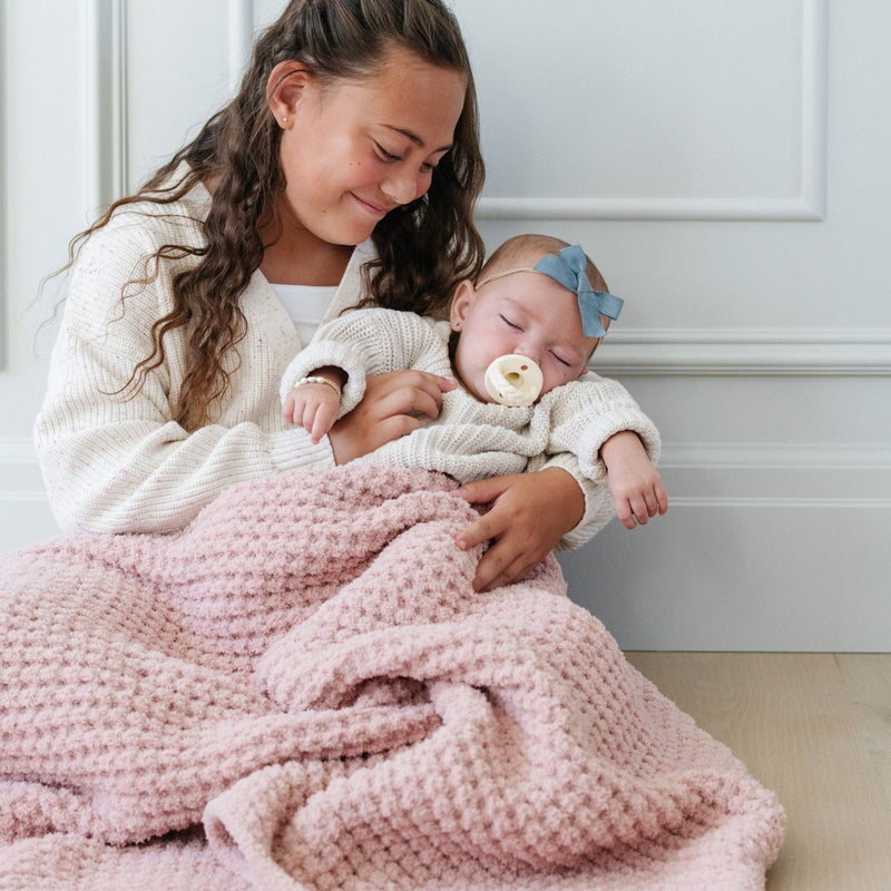 Mom holds baby using Saranoni Receiving Waffle Knit Blanket - Rosette