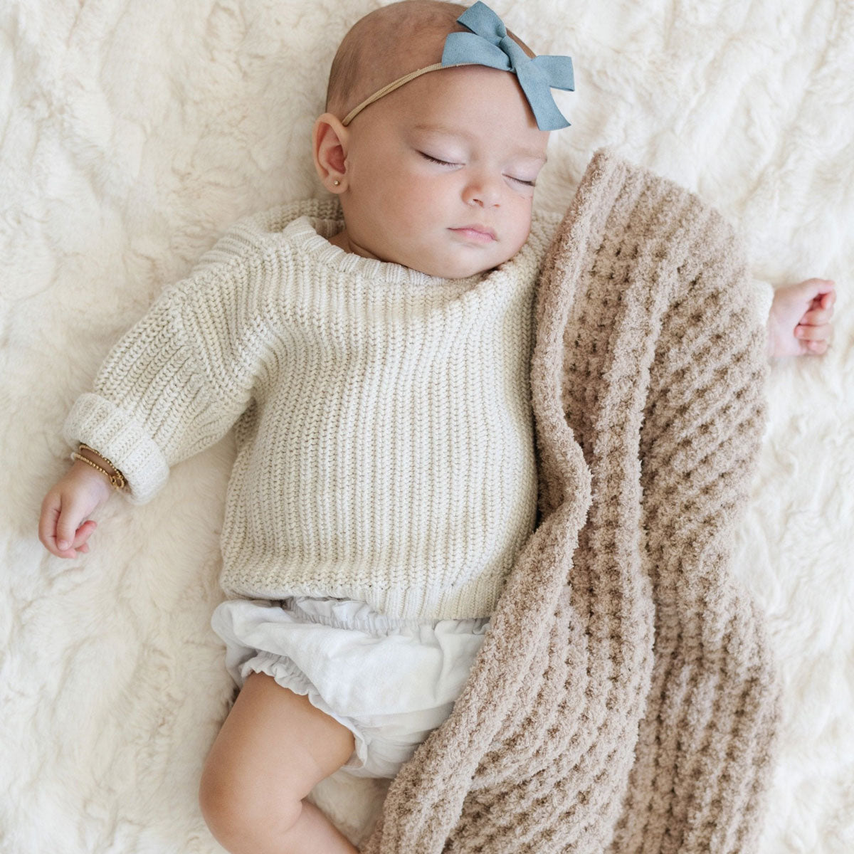Baby girl sleeps with Saranoni Receiving Waffle Knit Blanket - Wheat