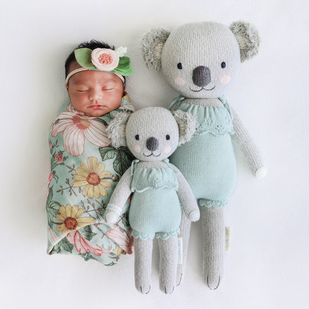 Newborn baby sleeping next to Cuddle and Kind Claire the Koala - Mint