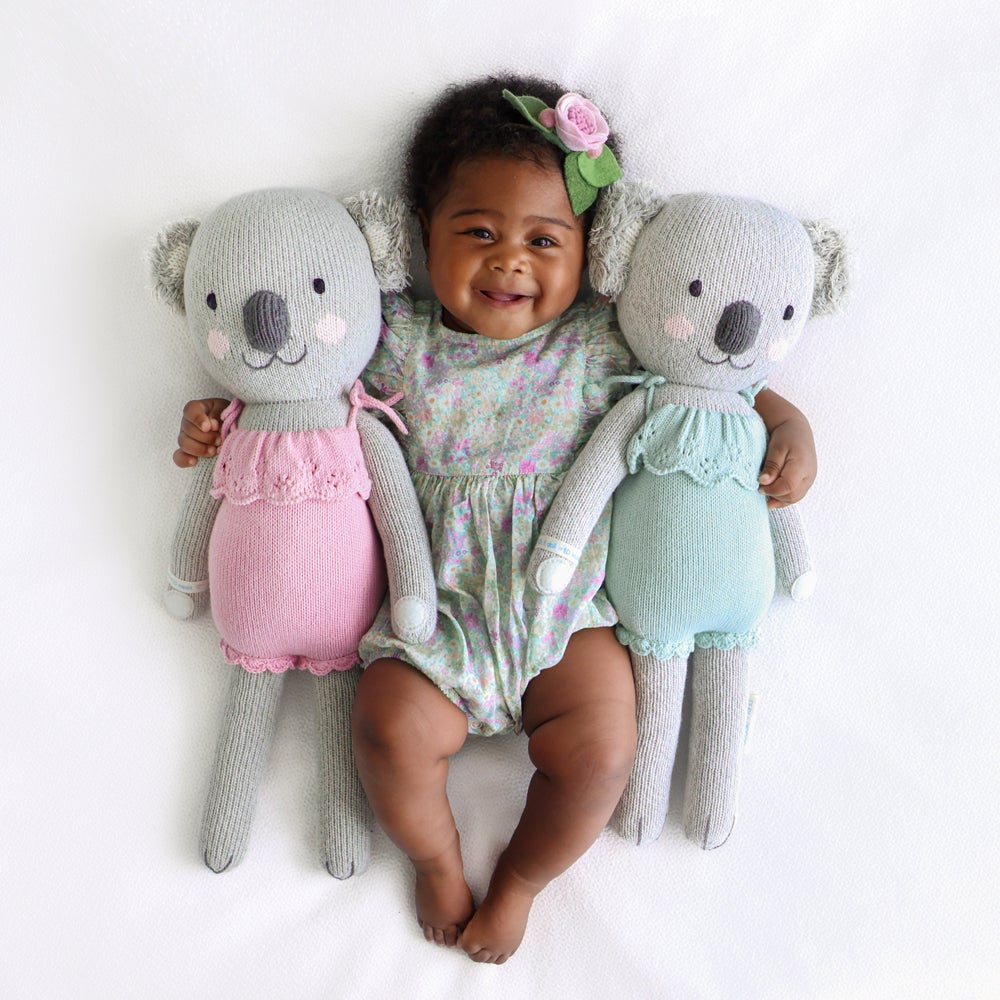 Baby smiling with arms around Cuddle and Kind Claire the Koala - Mint