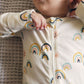Baby wearing Tea Collection Footed Zip Front Baby Romper - All Sunshine and Rainbows