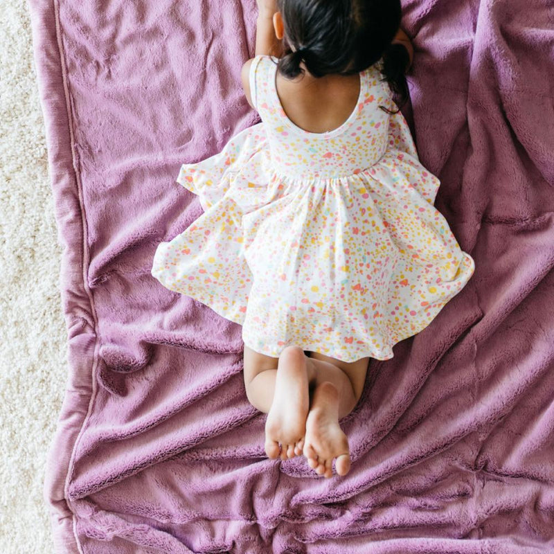Little Girl Laying on Saranoni Toddler Lush Blanket - Fairy Wings