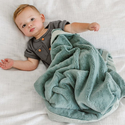 Little Boy laying with Saranoni Receiving Lush Blanket - Eucalyptus