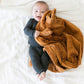 Baby snuggling with Saranoni Receiving Lush Blanket - Camel