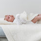 Baby laying on Saranoni Receiving Bamboni Blanket - Ivory