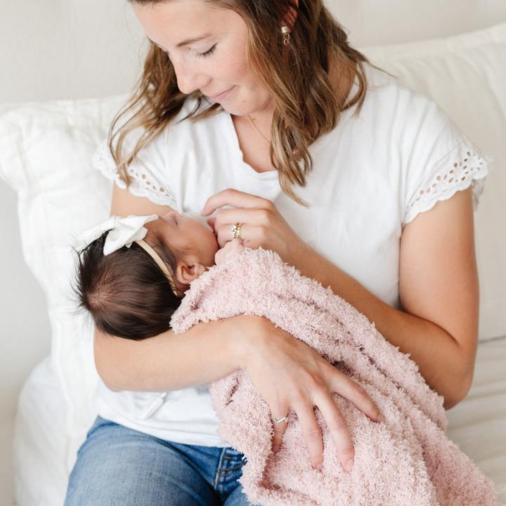 Mother holding baby wrapped in Saranoni Mini Ribbed Bamboni Blanket - Rose Dust
