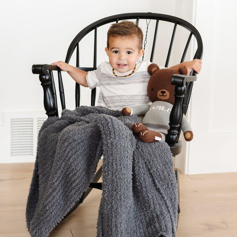 Little Boy sitting with Saranoni Receiving Ribbed Bamboni Blanket - Charcoal