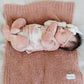 Baby laying on Saranoni Mini Bamboni Blanket - French Rose