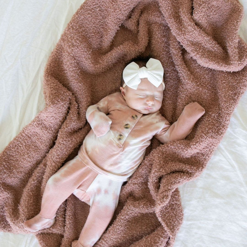Baby Girl laying on Saranoni Receiving Bamboni Blanket - French Rose