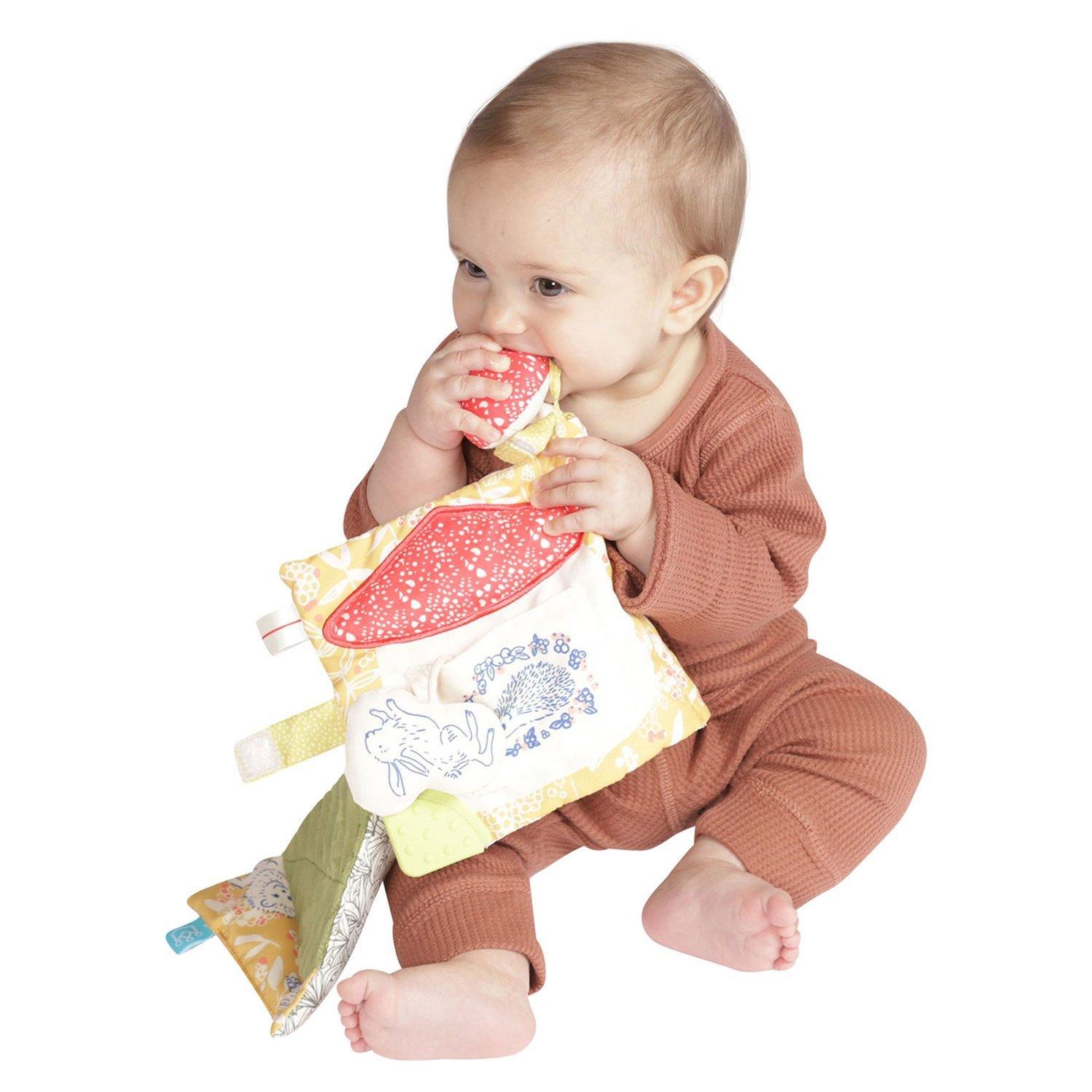 Baby chewing on Manhattan Toy Company Deer One Soft Book