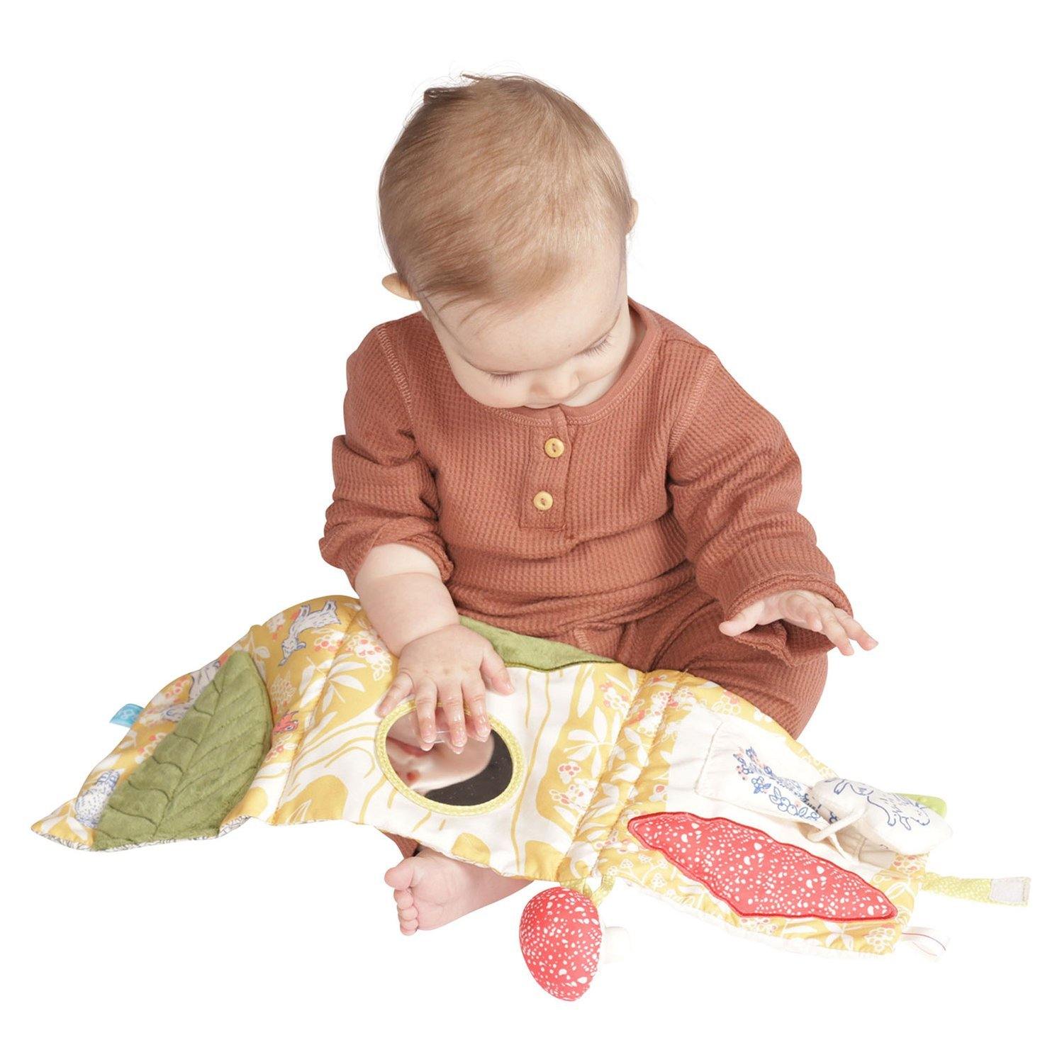 Baby playing with Manhattan Toy Company Deer One Soft Book