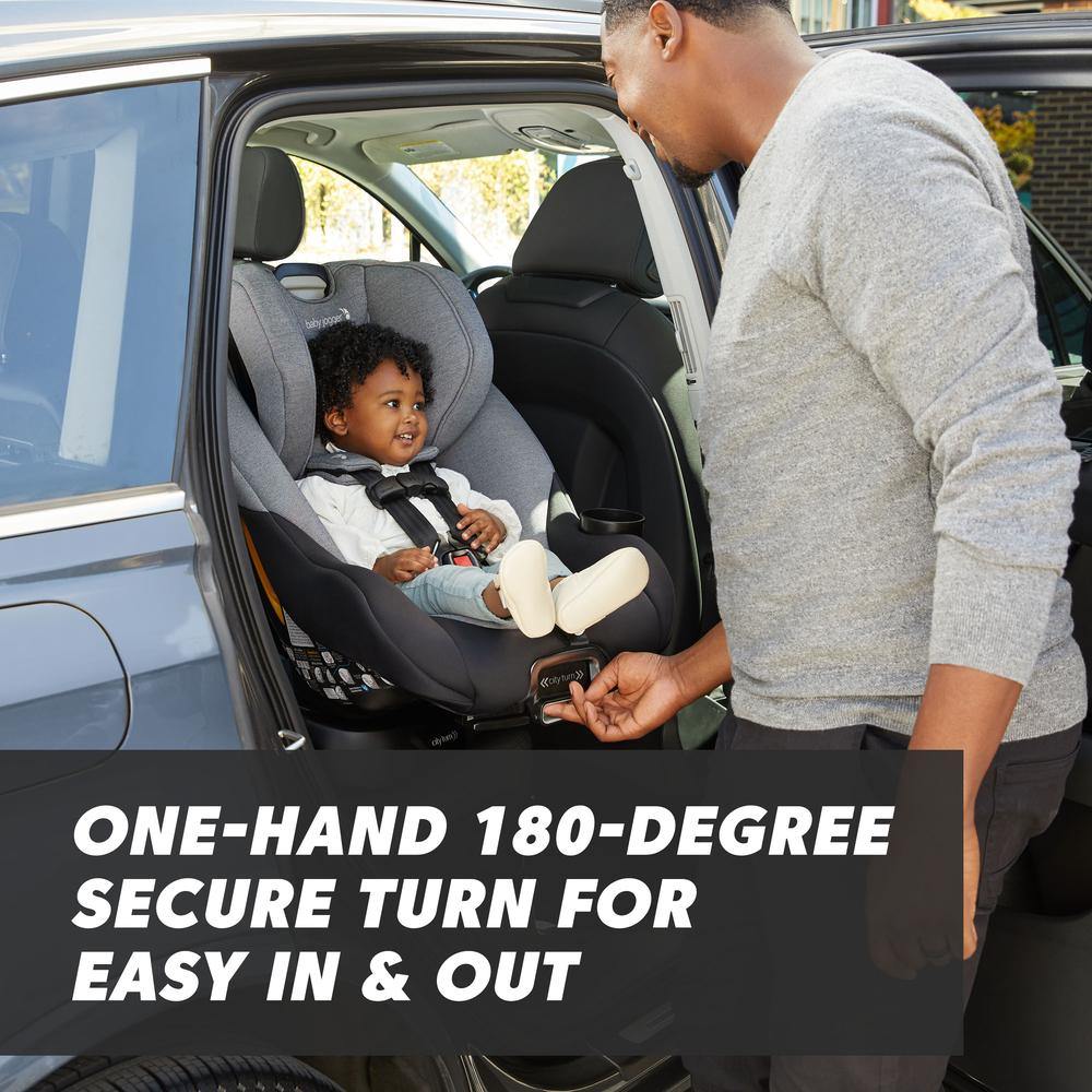 Man turns Baby Jogger City Turn Rotating Convertible Car Seat in car