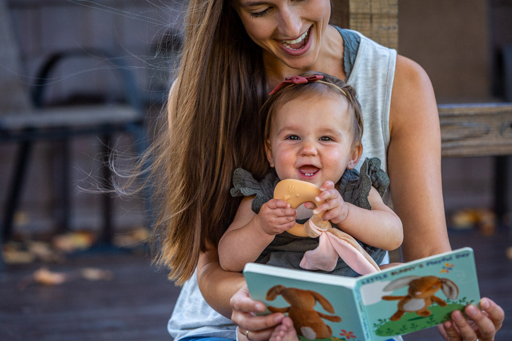 Mom reading to baby holding Mary Meyer Leika Teether - Little Bunny