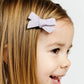 Girl wears Lou Lou and Company Linen Bow Clip - Pigtail Set - Small - Lavender