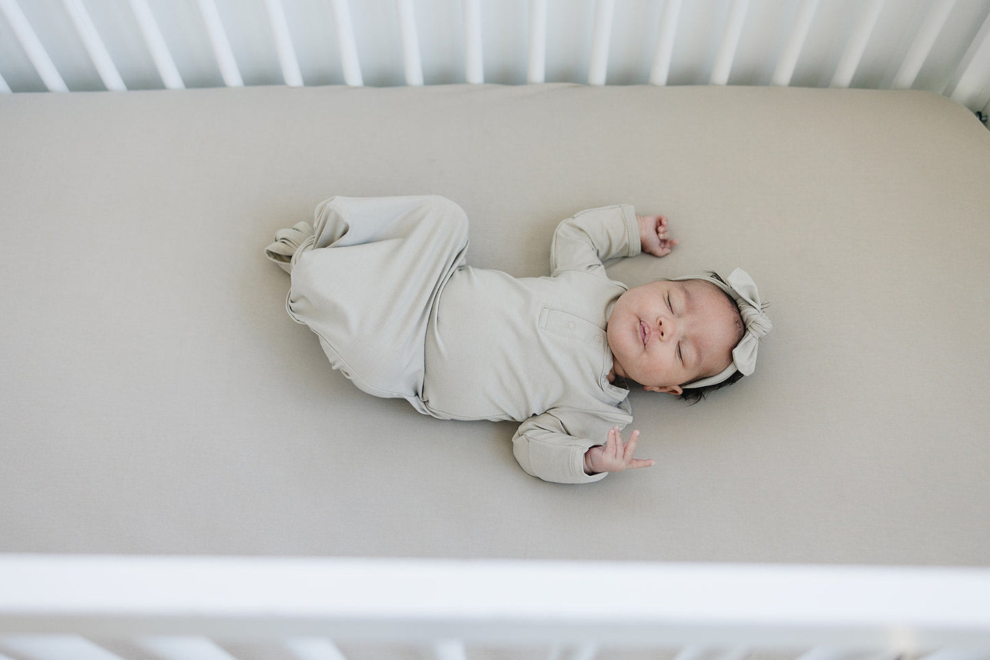Baby sleeping on Mebie Baby Bamboo Stretch Crib Sheet  - Oatmeal