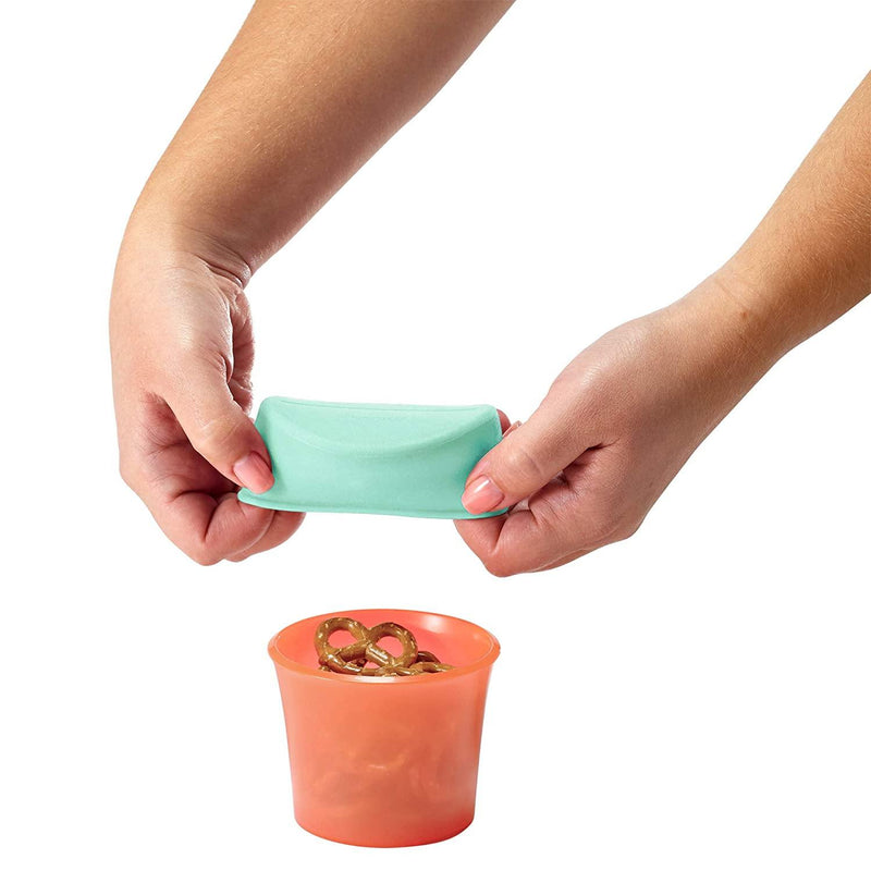 Person using Boon SNUG Snack Universal Silicone Snack Lids and Cups - Mint-Grey / Peach-Navy
