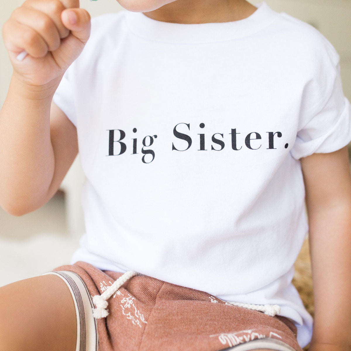 Child wearing The Baby Cubby Big Sister Tee - White