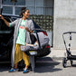 Woman holds Bugaboo Turtle Air by Nuna Infant Car Seat