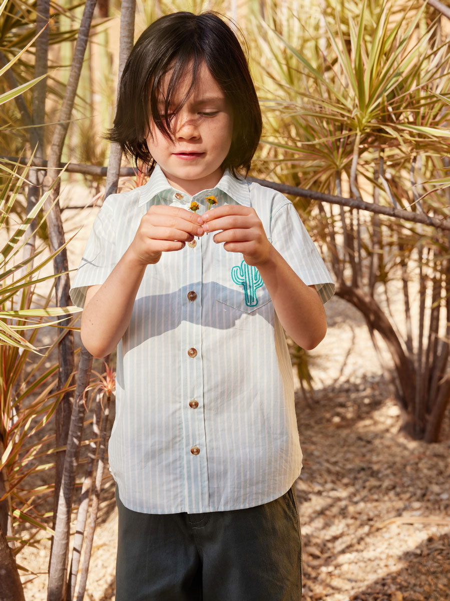 Boy wears Tea Collection Button Up Woven Shirt - Sea Stripe