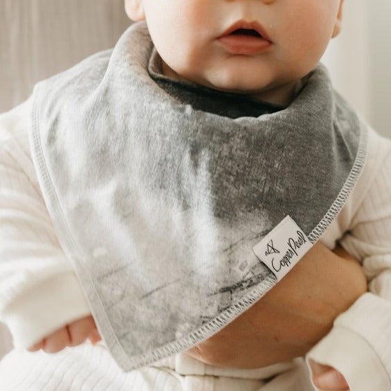 Baby wearing Copper Pearl Single Holiday Bandana Bib - Trick Washed-Out Grey