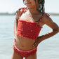 Girl in water wearing Fin and Vince Smocked Bikini - Paisley Trail Flame