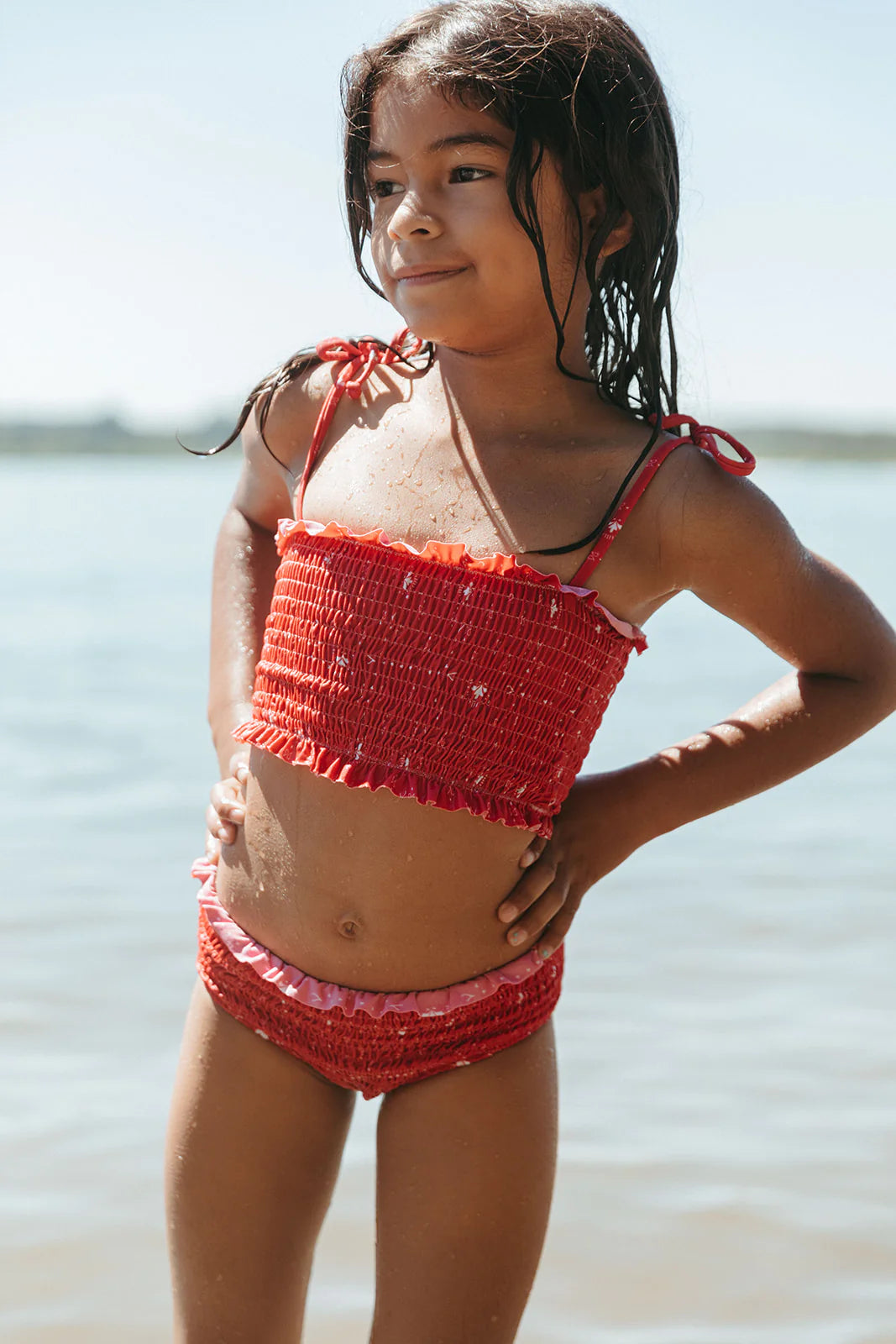 Girl in water wearing Fin and Vince Smocked Bikini - Paisley Trail Flame