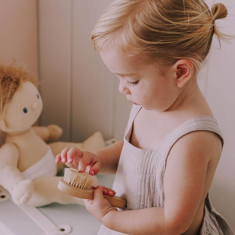 Girl touching Olli Ella Dinkum Doll Brush