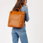 Woman holds Fawn Design Square Diaper Bag - Brown