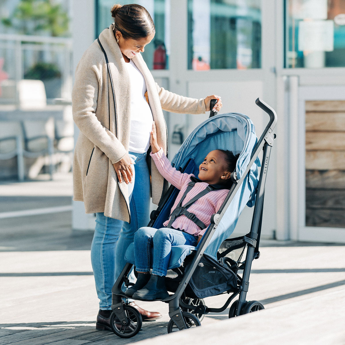 Woman looks at child in UPPAbaby G-LUXE Stroller - Charlotte